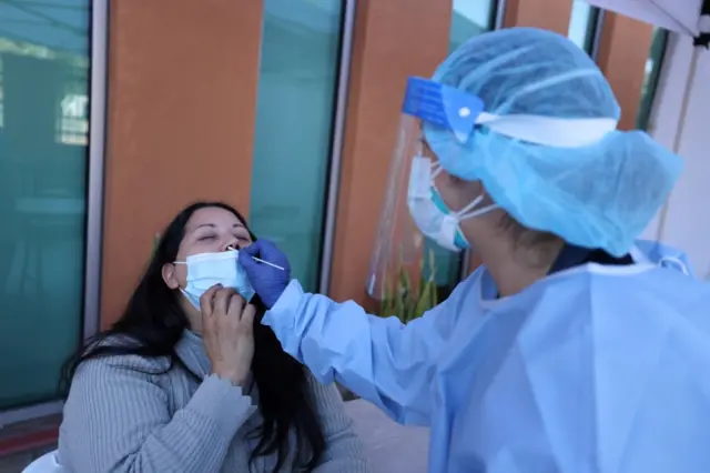 A woman is tested for the virus in Los Angeles