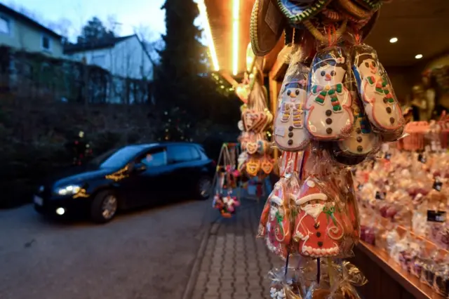 A car enters the drive-through Christmas market