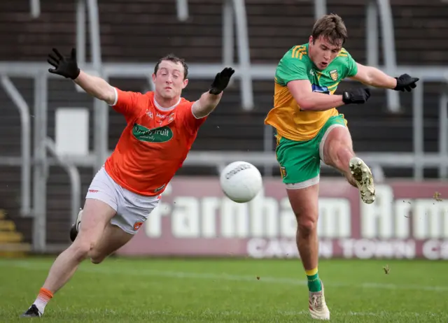 Peadar Mogan scores a goal despite the efforts of Ryan Kennedy