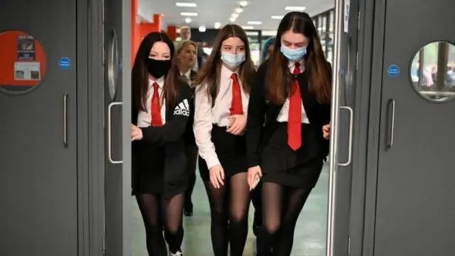 Pupils wearing masks in a corridor at secondary school