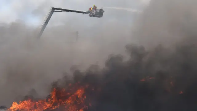 Firefighters work to put out the fire