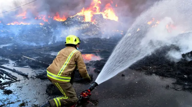 Firefighters work to put out the fire