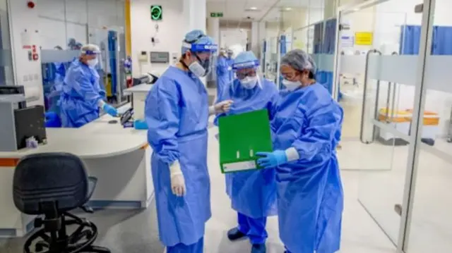 Health workers wearing full personal protective equipment