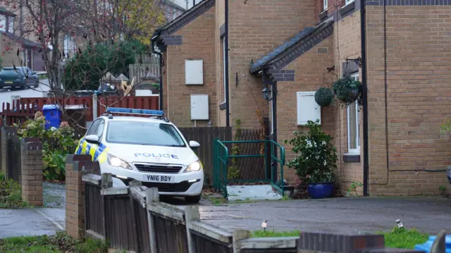 A police car outside a house