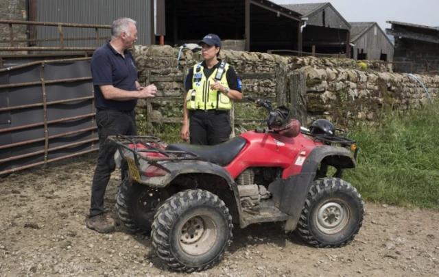 Police officer and farmer with bike