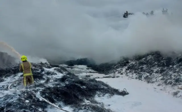 Foam being pumped onto burning tyres