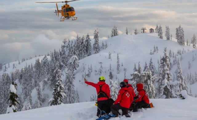 Meidcs in a mountain environment caring for casualty