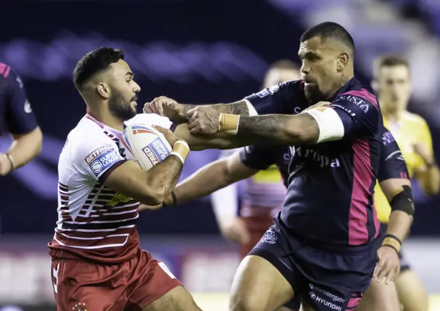 Wigan's Bevan French fends off Hull FC's Manu Ma'u