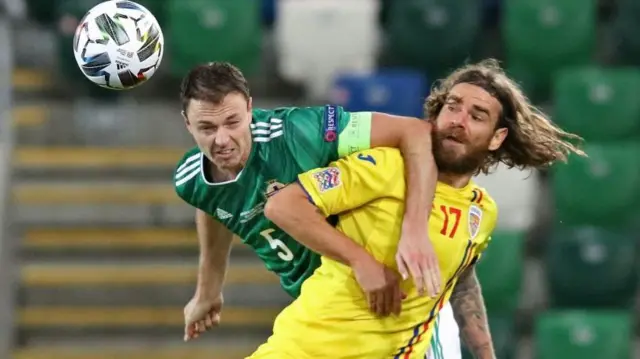 Jonny Evans competes for a header