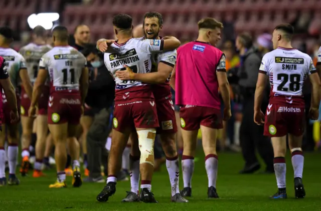 Sean O'Loughlin of Wigan shakes hands with teammates after winning