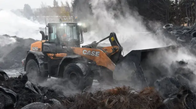 Digger clearing tyres