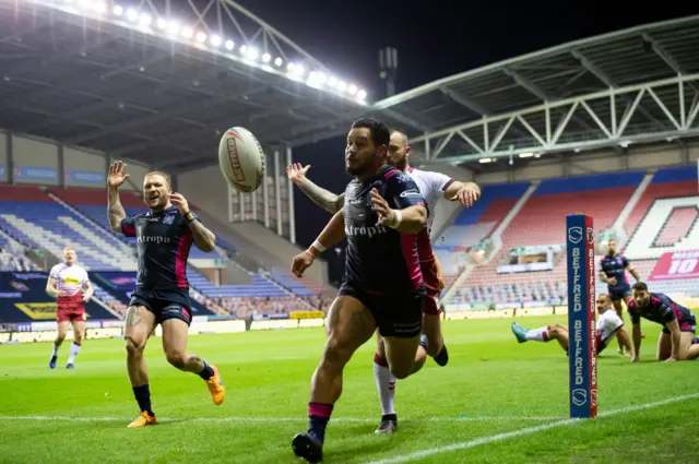 Hull FC's Bureta Faraimo chases the ball into Wigan's goal area