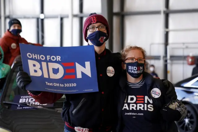 People hold signs at the get the vote out event in Cleveland