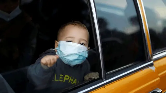 A young child wearing a mask