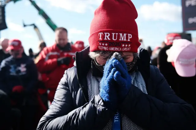 Supporters pray at a President Donald Trump rally on November 02, 2020 in Avoca, Pennsylvania. Donald Trump is crossing the crucial state of Pennsylvania in the last days of campaigning before Americans go to the polls on November 3rd to vote