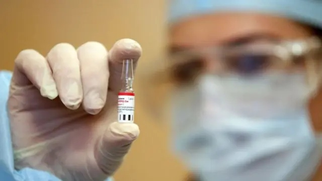 A scientist holding a tube