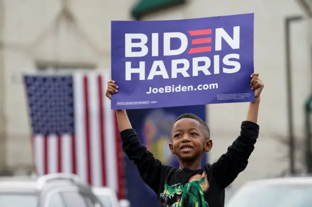 A child holds a sign as he attends U.S. Democratic presidential candidate Joe Biden"s campaign event in Philadelphia, Pennsylvania