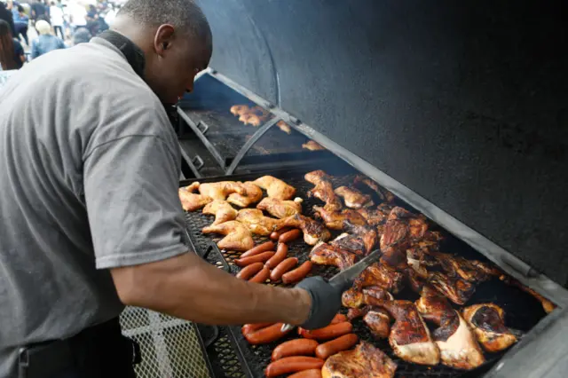 A man grills meat for the crowd