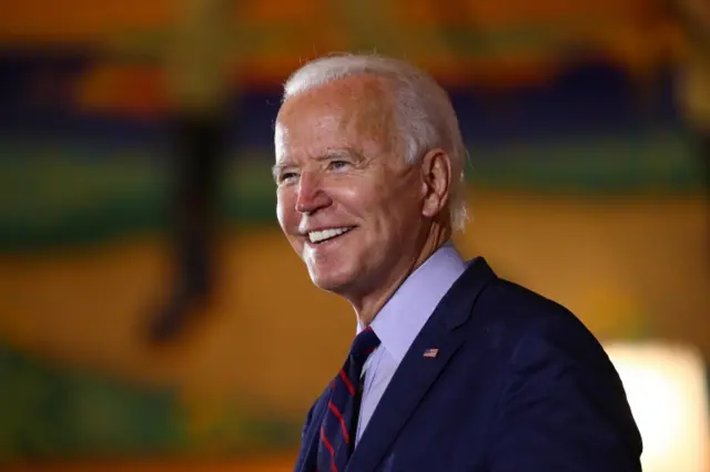 Joe Biden smiles at a campaign event on 12 October