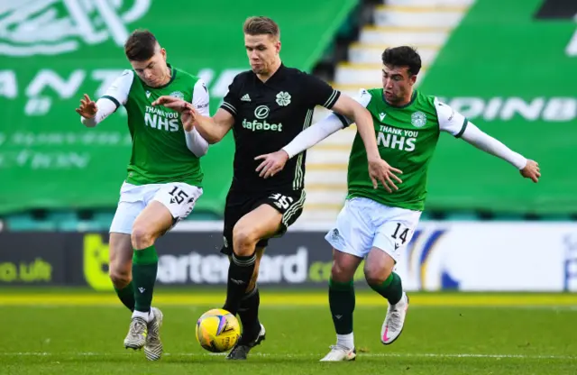 Celtic's Kristoffer Ajer vies for possession with Stevie Mallan (right) and Kevin Nisbet