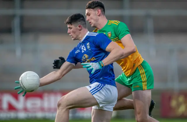 Cavan’s James Smith with Michael Langan of Donegal