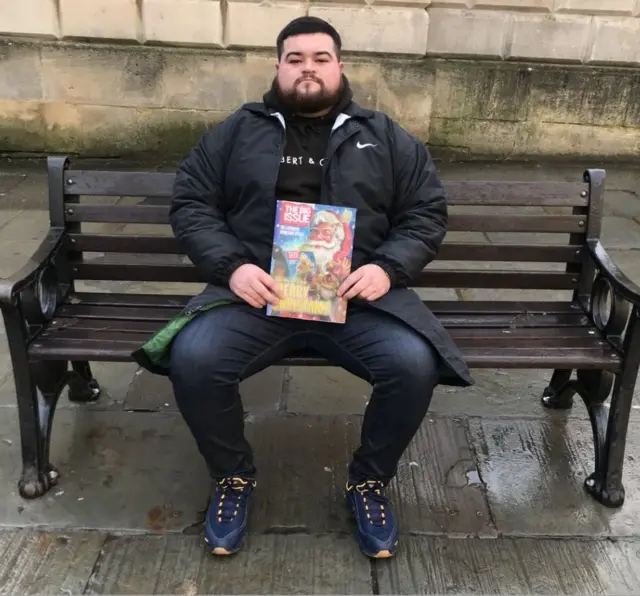 Samuel Wilmot sitting on a bench at Bath Abbey