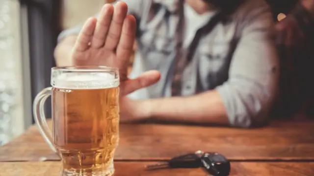 Man with beer and car keys