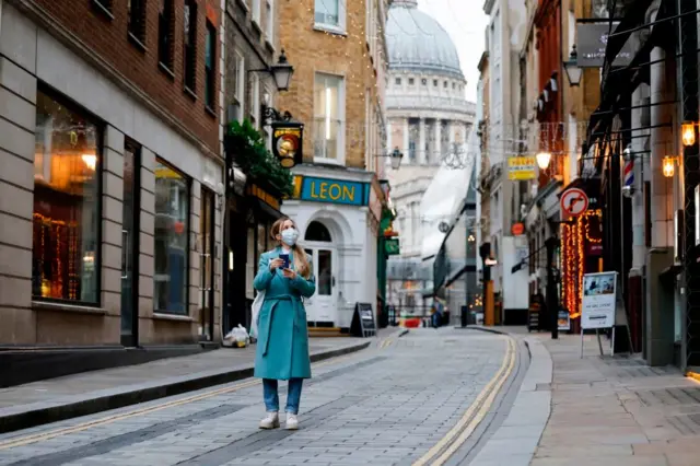 Woman wears face covering near St Paul's cathedral