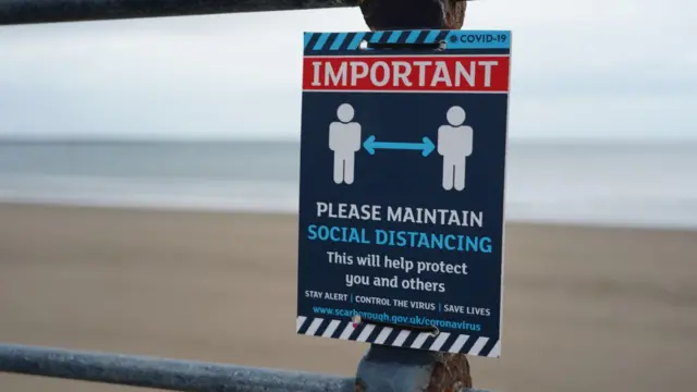 Social distancing sign on North Yorkshire coast