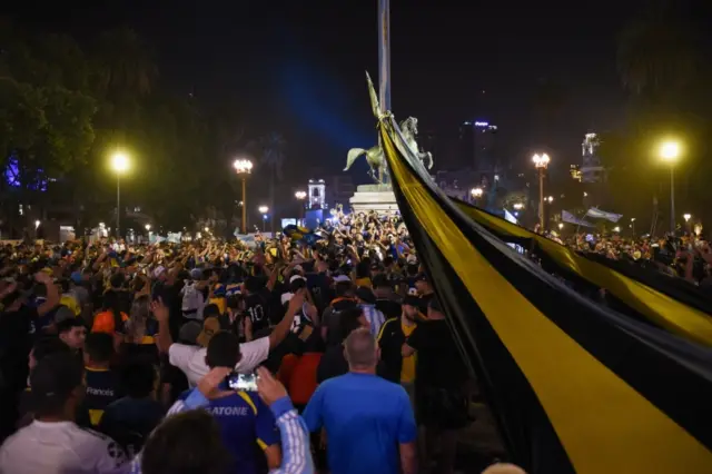 People gather outside the Casa Rosada presidential palace ahead of the wake of soccer legend Diego Maradona, in Buenos Aires, Argentina early November 26, 2020