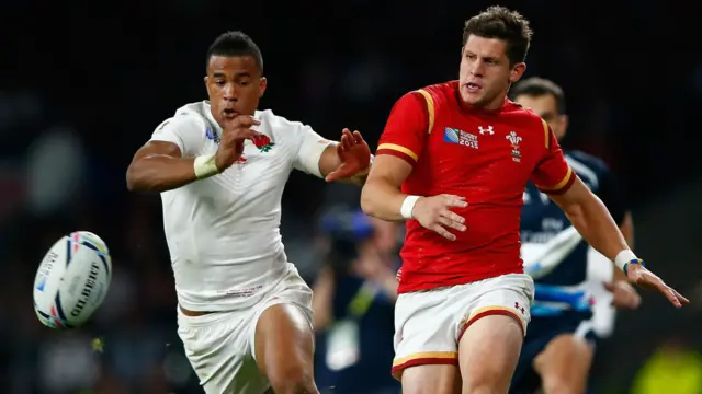 Lloyd Williams (right) kicks past Anthony Watson