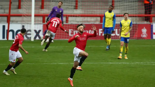 Cole Stockton celebrates a goal for Morecambe