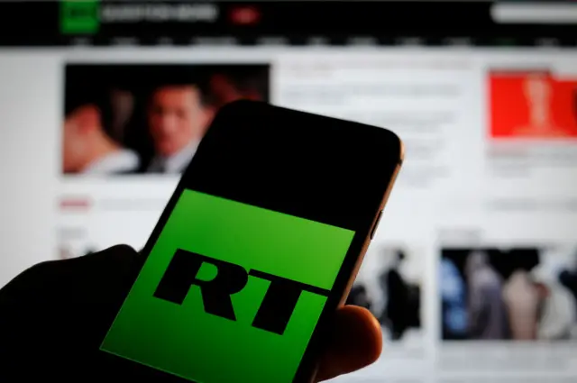 The Russia Today logo is seen on a iPhone