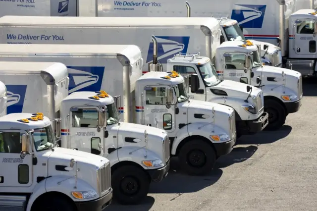 USPS vehicles at a processing and distribution centre