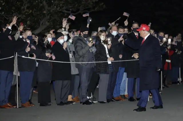 Trump greets guests on the South Lawn of the White House after arriving on Marine One in Washington