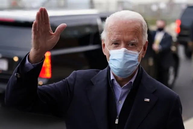 Joe Biden waves as he talks to reporters on Election Day in Wilmington, Delaware