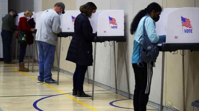 People fill out ballots at a polling station located at the McFaul Activity Center in Bel Air, Harford County, during early voting in Maryland, October 27, 2020.