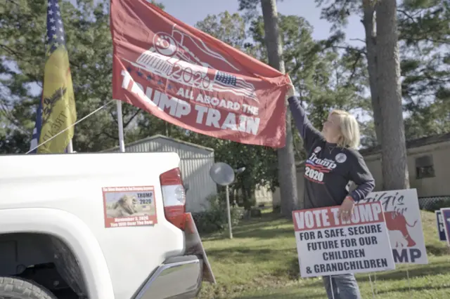 Angela Davidson proudly shows off her Trump flags outside of her local polling place in Nassau County, Florida.