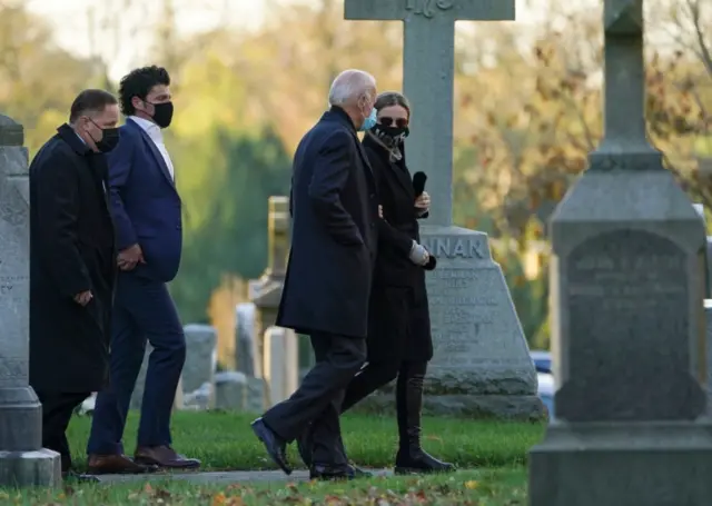 Joe Biden walks with granddaughter Finnegan as he attends church on election day