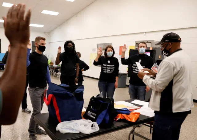 Poll workers take an oath at Fulton County polling station during the election in Atlanta, Georgia, U.S. November 3, 2020.