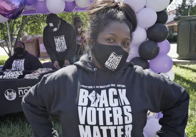 Local activist Kruzshander Scott poses outside of a polling place in Jacksonville, Florida.