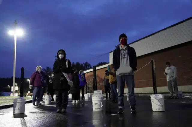 Voters line up at the Waterville Junior High School polling station before doors open during the election in Waterville, Maine, U.S. November 3, 2020