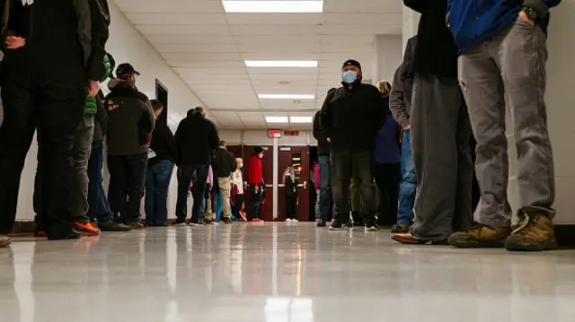 Voters wait in line to enter the polling place at Ballard High School on November 3, 2020 in Louisville, United States