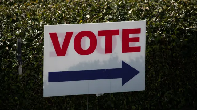 A Vote sign directs voters to the polling location at the Orange County Registrar of Voters in Santa Ana, California, U.S., October 16, 2020.