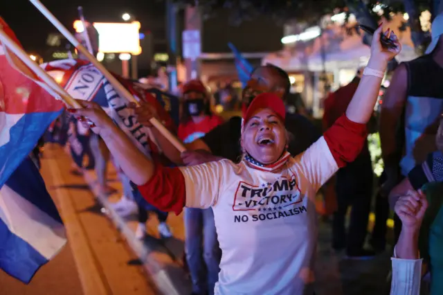 Supporters of President Donald Trump cheer outside of the Versailles restaurant as they await the results of the presidential election on November 03, 2020 in Miami, Florida