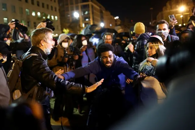 Men gesture as protesters gather at Black Lives Matter Plaza near the White House in Washington