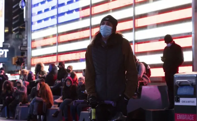 People gather to watch results in the presidential election on a screen in Times Square in New York