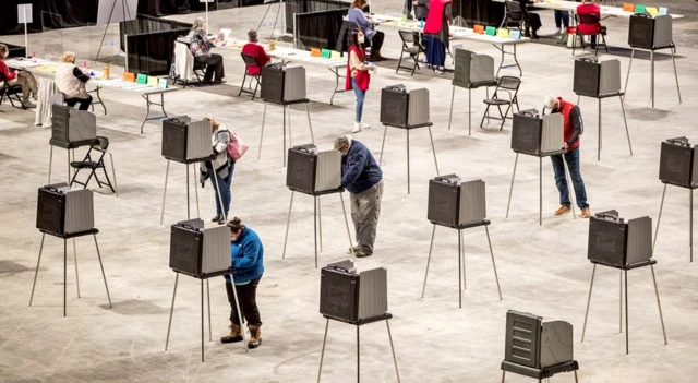 Voters cast their ballots at the Cross Insurance Center polling location in Bangor, Maine