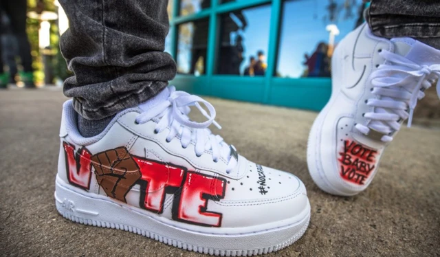 Artist Dababy shows off his shoes at a polling location in Charlotte, North Carolina