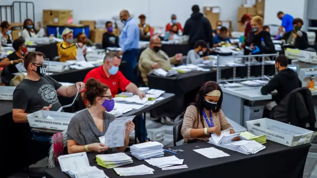 Absentee ballots are processed and verified by the Fulton County Registration and Elections Department in a large room at State Farm Arena in Atlanta, Georgia, USA, 04 November 2020.